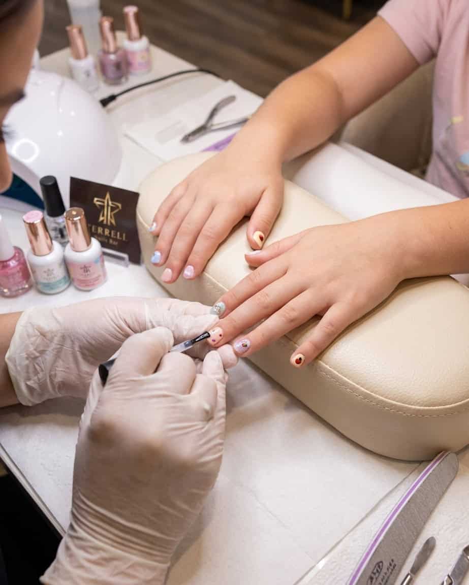 A little girl enjoying a professional kids nail salon Terrell service at our relaxing salon.
